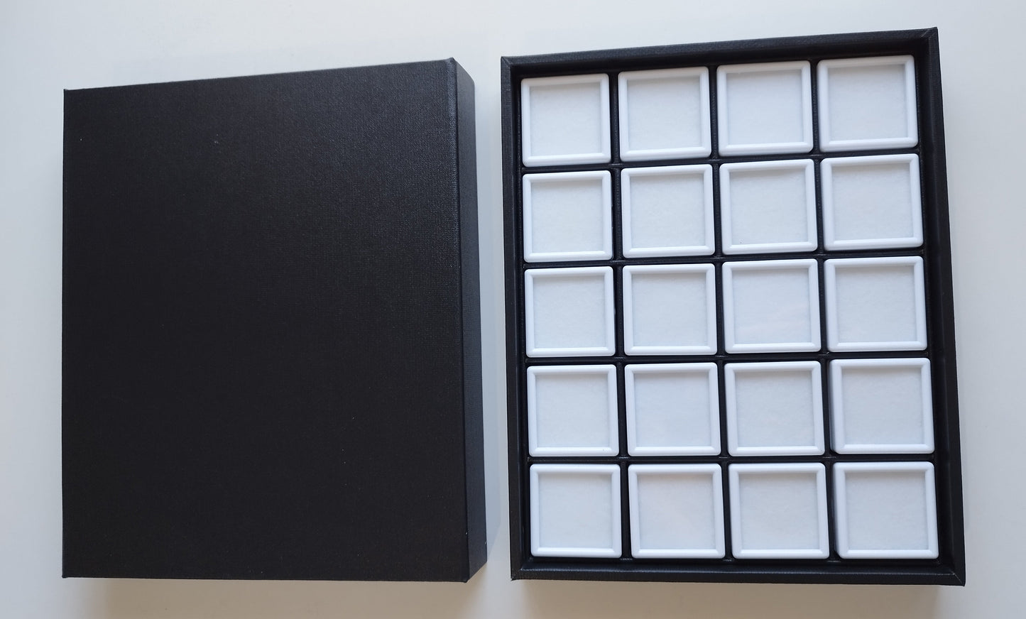 Black leather-style box with magnetic closure and sectioned interior. (23,5 * 19,5 * 3 cm)