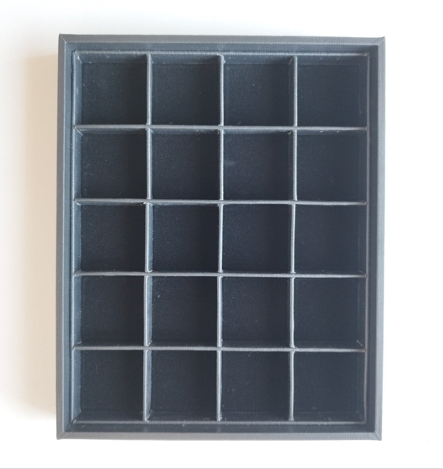 Black leather-style box with magnetic closure and sectioned interior. (23,5 * 19,5 * 3 cm)