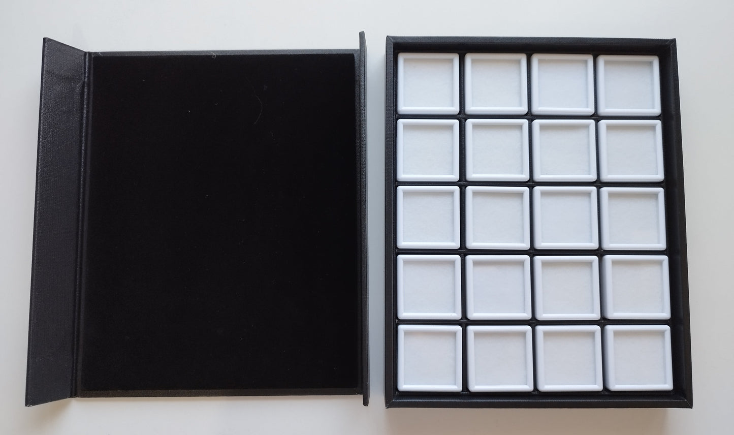 Black leather-style box with magnetic closure and sectioned interior. (23,5 * 19,5 * 3 cm)