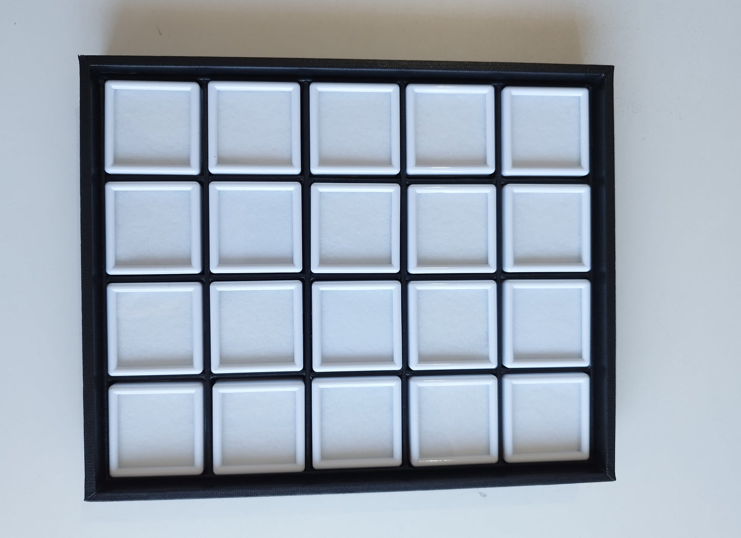 Black leather-style box with magnetic closure and sectioned interior. (23,5 * 19,5 * 3 cm)